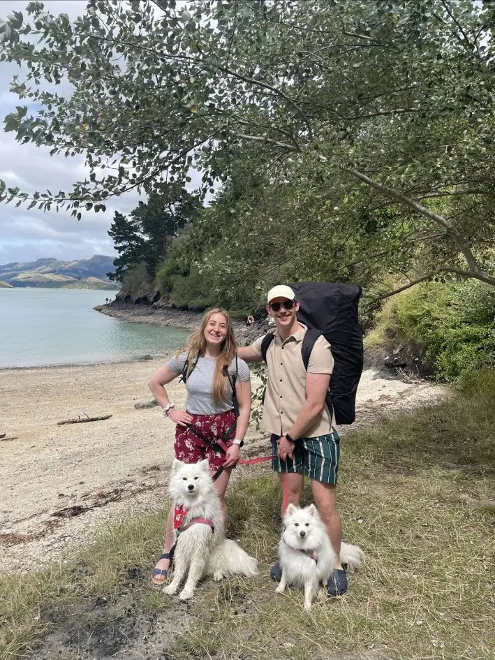 Newbee Meadery co-founders Harry Oram and Zoe Alexander with Bella and Kumo beside the water